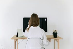 woman in white long sleeve shirt sitting on a chair